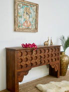 Side angle image of a teak wood console table made from antique Indian door parts; sustainable old door furniture, 183 × 95 × 45 cm.