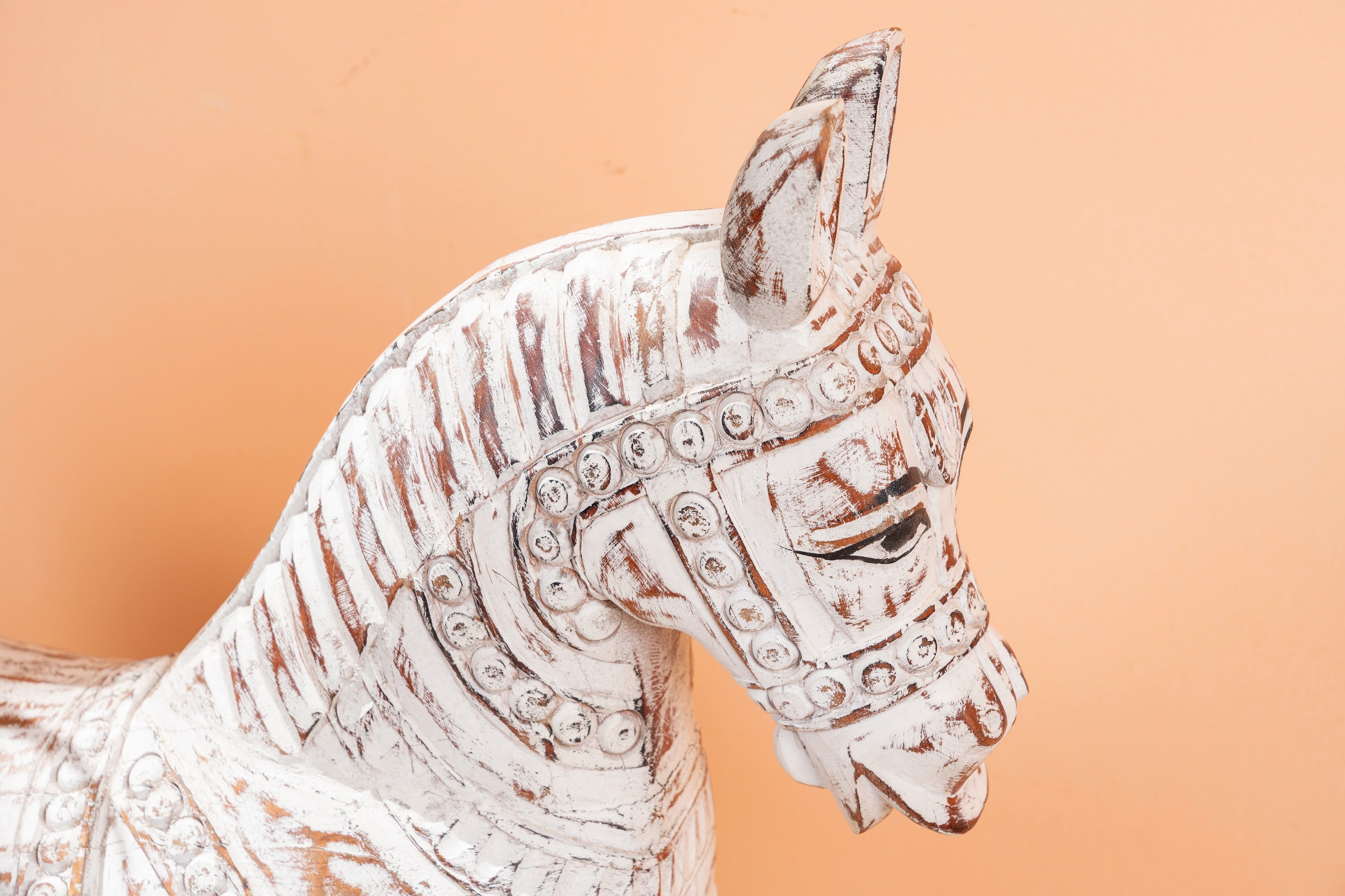 Close up image of a hand-carved whitewashed mango wood rocking horse – artistic Indian home accessory and mango wood décor, ideal for entryways or living rooms, 105x80x30cm.