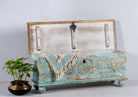 Side angle image of a hand-carved mango wood chest in blue with natural wood top – carved wooden furniture and wooden storage chest for eclectic or boho interiors.