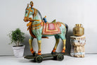 Large hand-painted Indian wooden horse sculpture on wheels – Rajasthani mango wood decor piece, ideal as artistic Indian home accessory, 110x90x30cm.