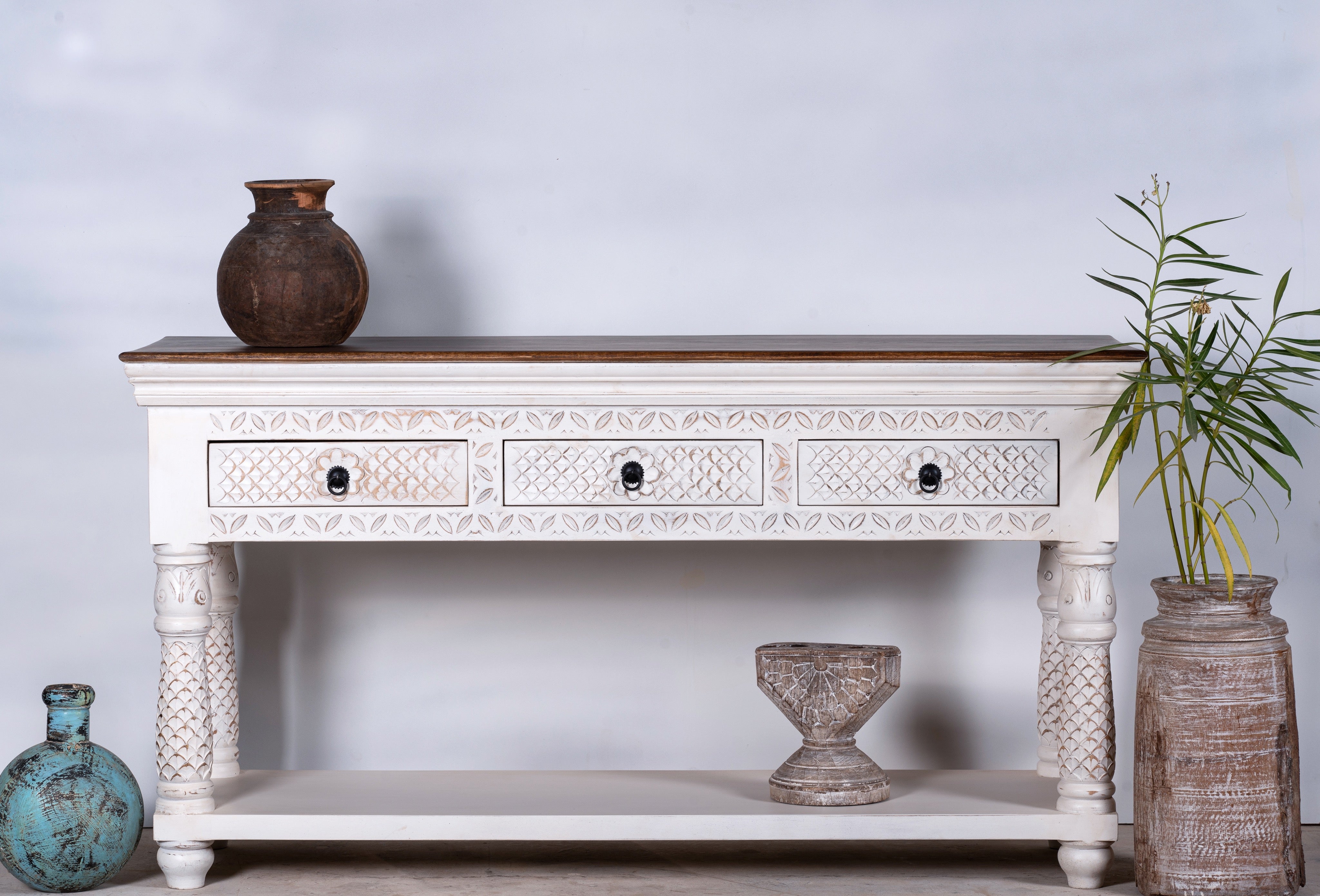 Carved mango wood console table with floral ornamentation; rich, exotic mango wood furniture, 150 × 90 × 45 cm.