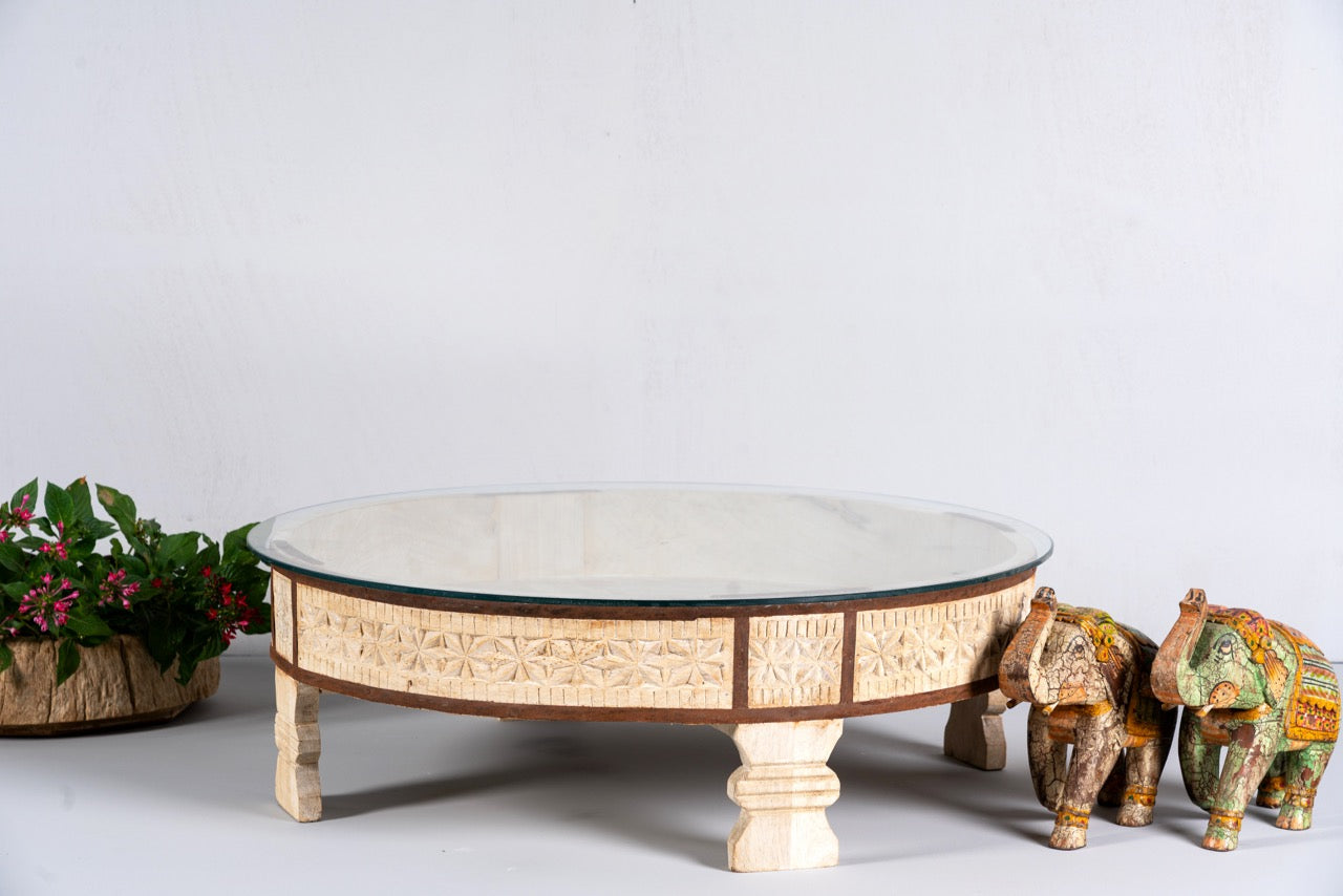 Round reclaimed wood coffee table with glass top and hand-carved Indian design; hollow interior, 70 cm diameter, 30 cm height.