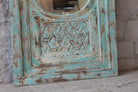 Close up image of a tall vintage wall mirror with hand-carved mango wood frame; rustic hand carved mirror, 86 × 160 × 5 cm.