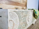 Close up image of a hand-carved mango wood vintage chest with whitewashed finish and iron fittings – elegant storage for bohemian or rustic interiors.