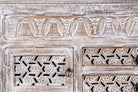 Close up image of a hand-carved wooden sideboard made from solid mango wood with drawers and compartments; unique furniture piece in Mediterranean style, 180 × 100 × 40 cm.