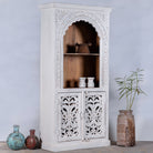 Side angle image of a handcrafted mango wood shelving unit with Indian carvings and four compartments; ideal for Indian home decor, 180 × 90 × 40 cm.