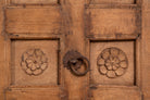 Close up image of a Okha antique Indian teak door repurposed as a decorative wall panel or old door headboard, featuring original hand-carved detailing and a naturally aged finish—an authentic piece of old Indian door furniture.
